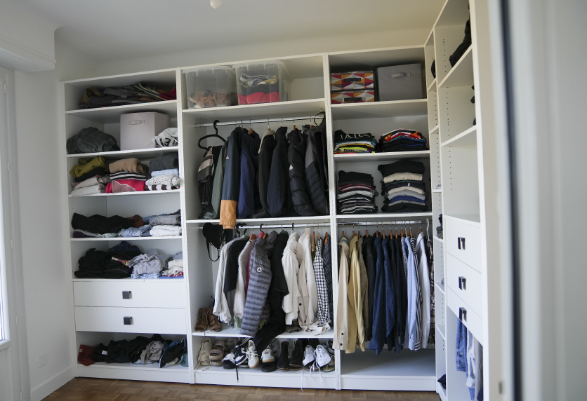 Dressing blanc ouvert avec deux niveaux de penderie et des rangements pour vêtements, dans un projet d’agencement intérieur à Audignon