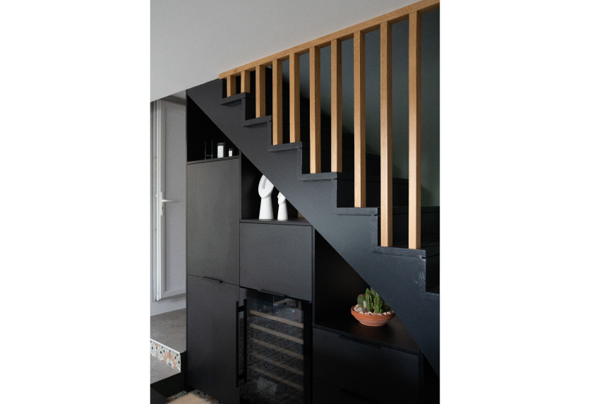 Sous un escalier à Castelnau-Tursan, agencement intérieur avec rangements anthracite, niches et garde-corps en bois